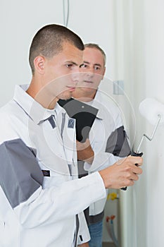 Skilled painter with apprentice