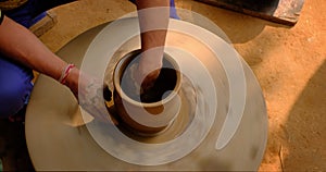 Skilled potter hands shaping the clay on potter wheel. Pot throwing handicraft bowl, jar, pot, jug. Rajasthan, India