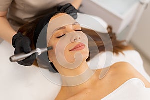 Revitalizing skin treatment with microneedling and mesotherapy technique in a serene spa environment photo