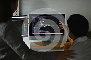 Skilled software developer team programming code on the computer for cyber security