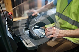 Skilled warehouse worker driving an electric forklift