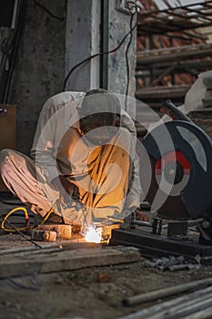 Skilled Welder welding metal in his Workshop