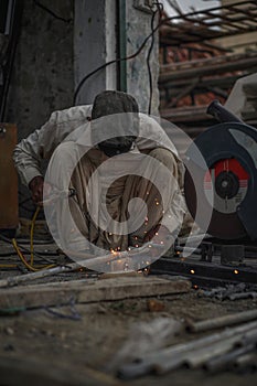 Skilled Welder welding pipes in Workshop