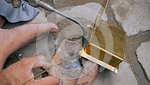 A skilled worker is brazing the metal