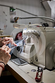 Skilled Worker Operating an Overlock Sewing Machine