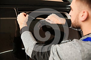 Skilled worker tinting car window