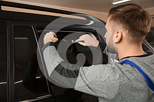 Skilled worker tinting car window
