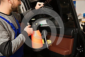 Skilled worker tinting car window