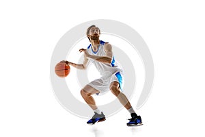 Skilled young man, basketball player in motion with ball demonstrating dribbling technique isolated on white background
