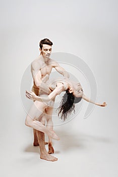 Skillful dancers performing in front of the white background