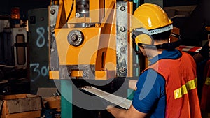 Skillful factory worker or engineer do machine job in manufacturing workshop