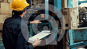 Skillful factory worker working with clipboard to do job procedure checklist .