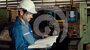 Skillful factory worker working with clipboard to do job procedure checklist .