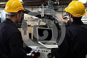 Skillful factory worker working with laptop computer to do procedure checklist .