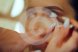 Skillful Makeup Artist Applying Eye pencil on Waterline