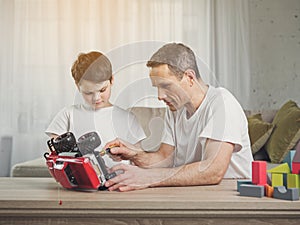 Skillful man fixing a toy car of his kid