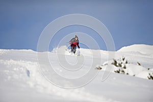 Skillful skier skiing downhill