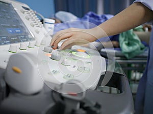 Skillful sonographer using ultrasound machine at work photo