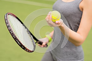 Skillful tennis player carrying the equipment