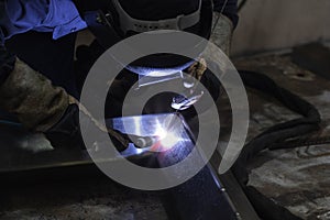 Skillful welders weld steel in the factory.