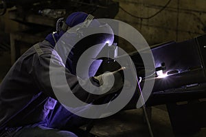 Skillful welders weld steel in the factory.