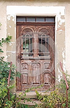 Skillful wooden entrance door of an abandoned house