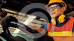 Skillful worker drives forklift in the factory .