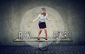 Skillful young business woman balancing between reward and risk