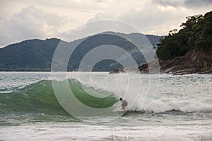 Skim boarder riding a wave