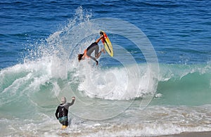 Skimboarder being photographed at Aliso Beach, Laguna Beach, CA