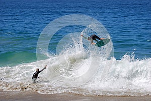 Skimboarder being photographed at Aliso Beach, Laguna Beach, CA
