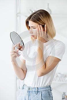 skin aging dermatology problem woman face mirror