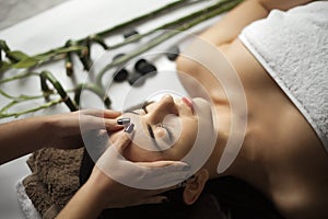 Skin And Body Care. Close-up Of A Young Woman Getting Spa Treatment At Beauty Salon. Spa Face Massage. Facial Beauty Treatment. S