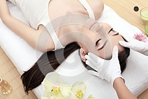 Skin And Body Care. Close-up Of A Young Woman Getting Spa Treatment At Beauty Salon. Spa Face Massage. Facial Beauty Treatment. Sp