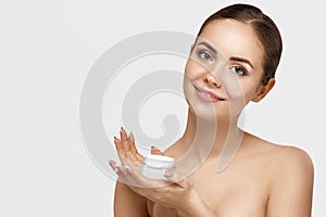 Skin Care. Beauty Concept. Young Woman Holding Cosmetic Cream. Soft Skin Model With Nude Make-Up.