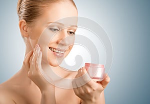 Skin care. beauty woman with eyes closed with jar of cream