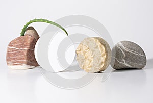 Skin care, body care products soap and solid shampoo and packaging with a place to copy on the background of stones and a leaf o