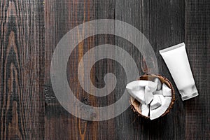 Skin care. Coconut cream on wooden table background top view copyspace