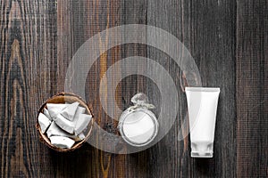 Skin care. Coconut oil and cream on wooden table background top view copyspace