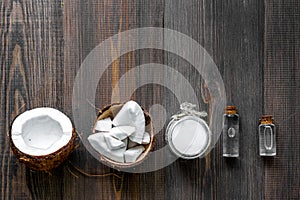 Skin care. Coconut oil and lotion on wooden table background top view copyspace