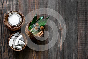 Skin care. Coconut oil and lotion on wooden table background top view copyspace