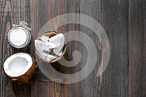 Skin care. Coconut oil on wooden table background top view copyspace