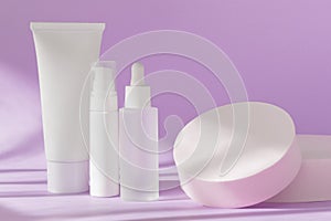 Skin care cosmetic bottles mockup on lilac. Cream jar tube, serum glass bottle template, lotion dispenser on natural