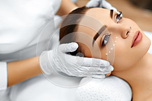 Skin Care. Cosmetic Cream On Woman's Face. Beauty Spa Treatment