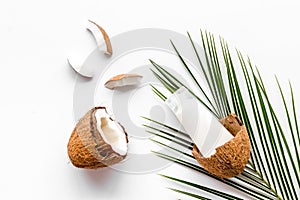 Skin care cream with coconut oil on white background top-down