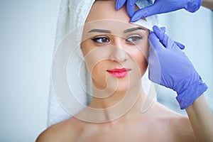 Skin care. Experienced cosmetician pulling out brows