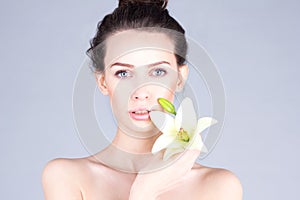 Skin care. Face of woman with lily. SPA and beauty.