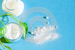 skin care with natural products baking soda,  coconut oil - top view on bright blue background