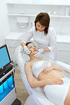 Skin Care. Pregnant Woman On Face Cleansing At Beauty Clinic