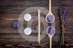 Skin care and relax. Cosmetics and aromatherapy concept. Lavender spa salt on dark wooden background top view